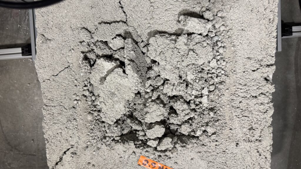 Post-test material surface showing excavation behavior in Cislune material work