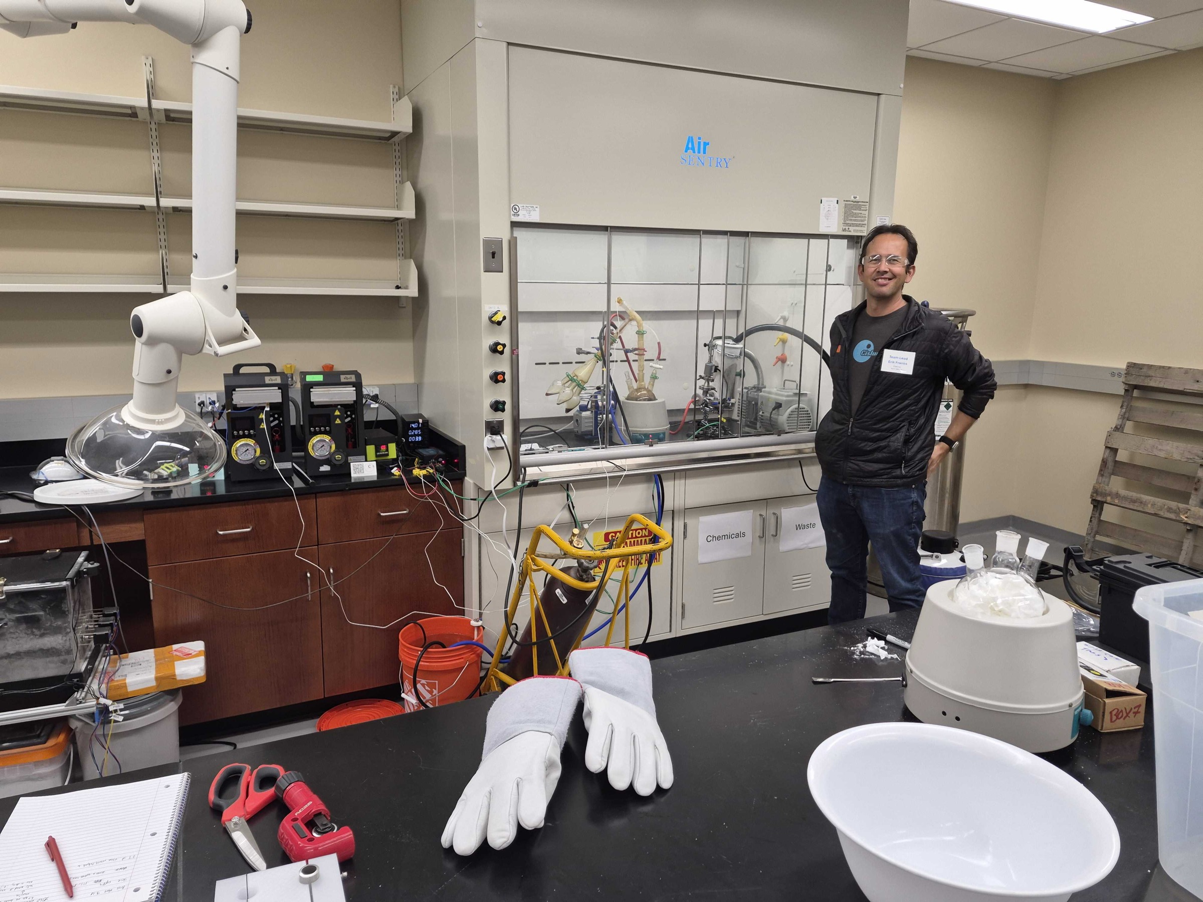 Erik Franks stands beside the CRAFTER lab-scale hardware, controls, and material-handling setup used during the LunaRecycle finals campaign.