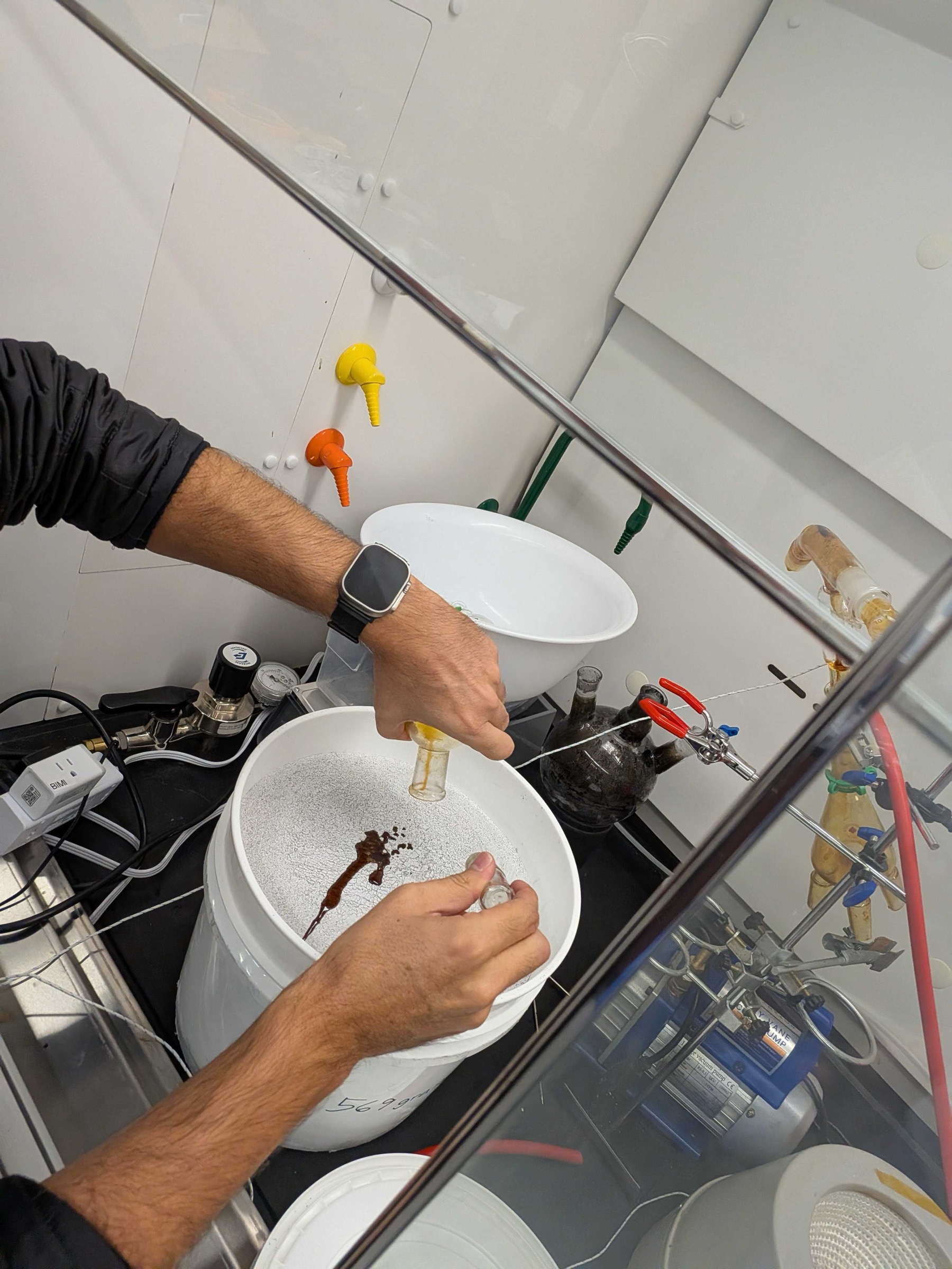 A Cislune team member recovers processed material from the CRAFTER lab apparatus during LunaRecycle finals testing.